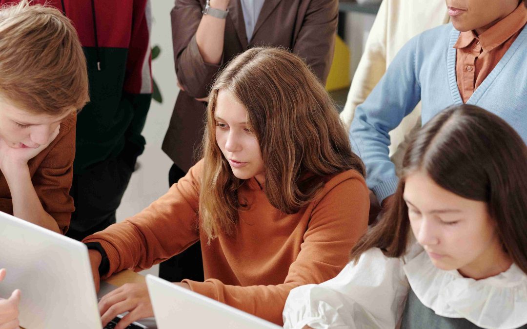 teens gathering around laptop Civic